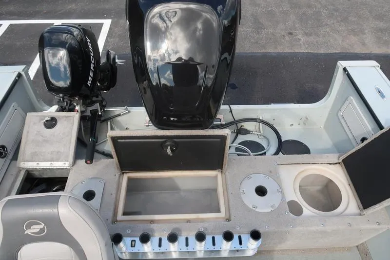 Slide: The Image of 2008 Starcraft STX PRO 2050 boat interior with Mercury engine and storage compartments. - 64