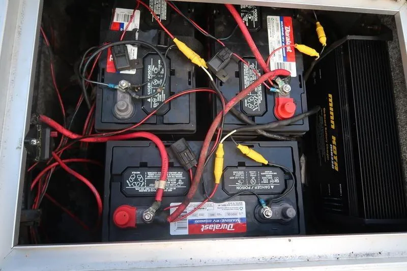 Slide: The Image of Four batteries with red and yellow cables in a 2008 Starcraft STX PRO 2050. - 67