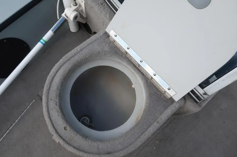 Slide: The Image of 2008 Starcraft STX PRO 2050 boat compartment with open hatch and fishing rod holder. - 72