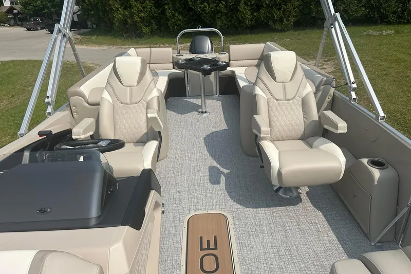 Slide: The Image of 2025 Tahoe 2585 boat interior with beige seating and modern design. - 11