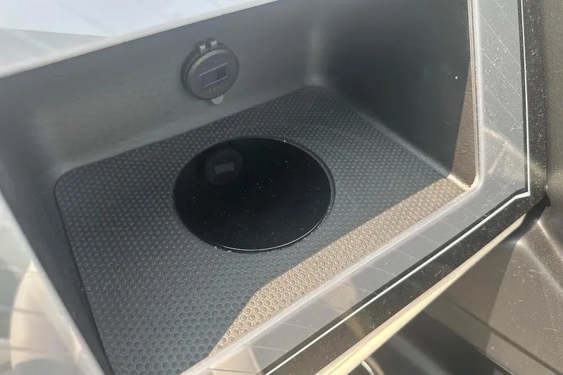 Slide: The Image of 2025 Tahoe 2585 interior storage compartment with USB port and sleek design. - 23