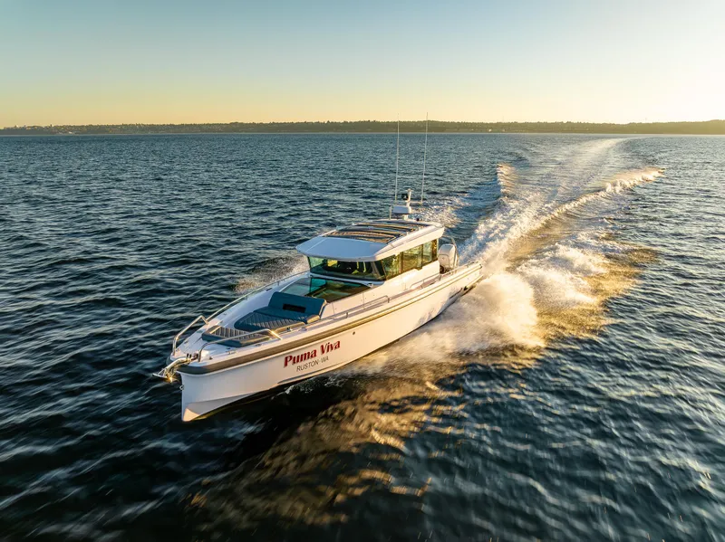 Slide: The Image of Axopar 37 XC 2022 cruising on open water at sunset. - 0