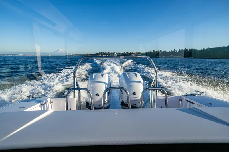 Slide: The Image of Axopar 37 XC 2022 boat cruising on open water with twin engines. - 13