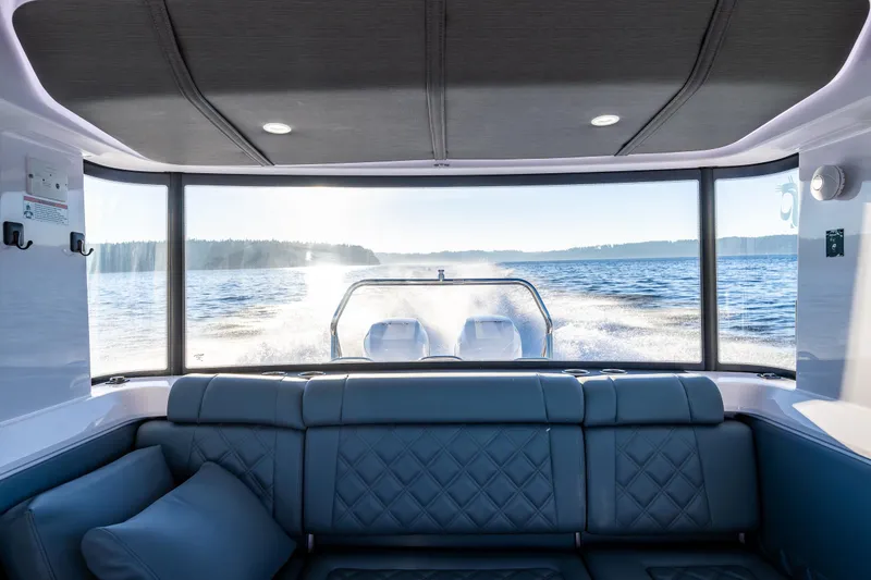 Slide: The Image of Interior view of 2022 Axopar 37 XC boat with scenic water backdrop. - 14