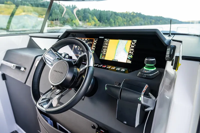 Slide: The Image of Axopar 37 XC 2022 dashboard with steering wheel and navigation display. - 17