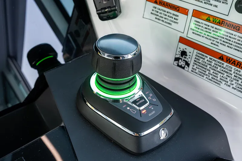Slide: The Image of Joystick control on 2022 Axopar 37 XC boat dashboard with warning labels. - 18