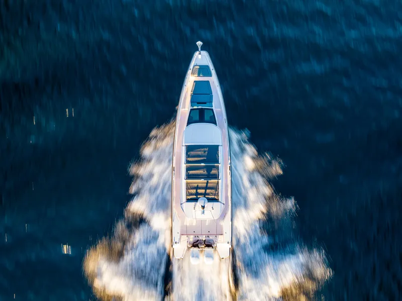 Slide: The Image of Aerial view of 2022 Axopar 37 XC boat cruising on water. - 2
