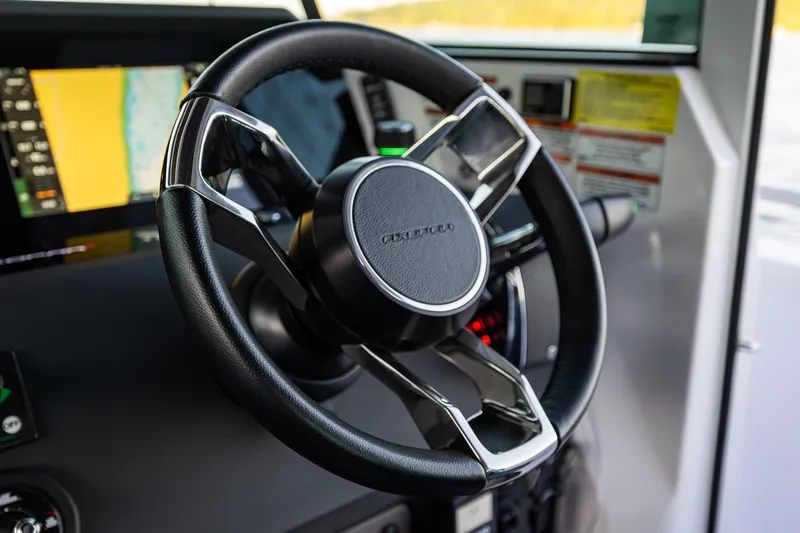 Slide: The Image of Steering wheel of 2022 Axopar 37 XC boat with navigation display. - 23
