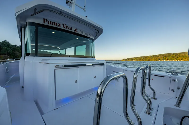 Slide: The Image of Axopar 37 XC 2022 boat on water, sleek design, stainless steel railings. - 25