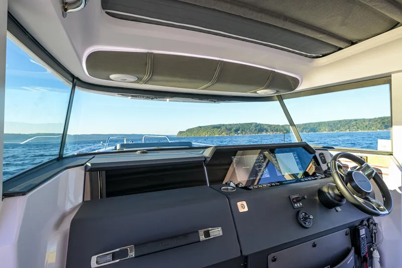 Slide: The Image of Interior view of 2022 Axopar 37 XC boat cockpit with scenic ocean backdrop. - 8