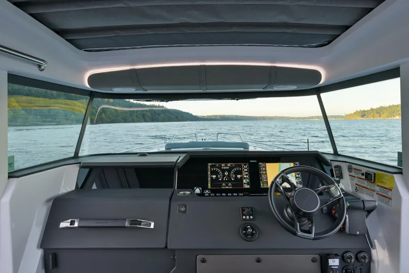 Slide: The Image of Interior view of 2022 Axopar 37 XC boat cockpit with steering wheel and dashboard. - 9