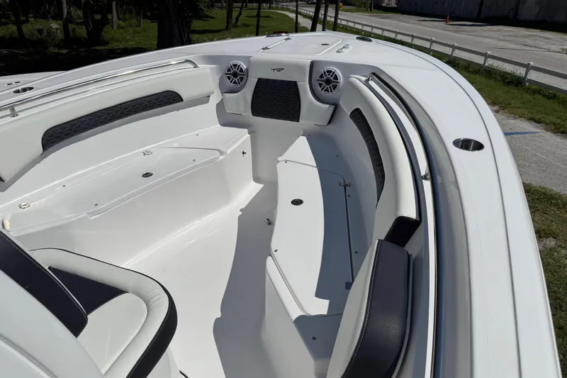 Slide: The Image of 2026 Tidewater 232 CC Adventure boat interior with seating and speakers. - 10