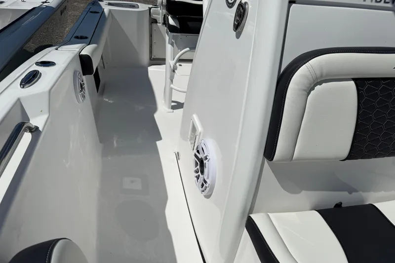 Slide: The Image of 2026 Tidewater 232 CC Adventure boat interior with white seating and speaker. - 13