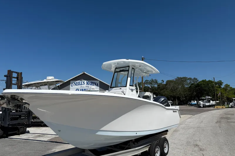 Slide: The Image of 2026 Tidewater 232 CC Adventure boat at O'Neil's Marina under clear blue sky. - 4