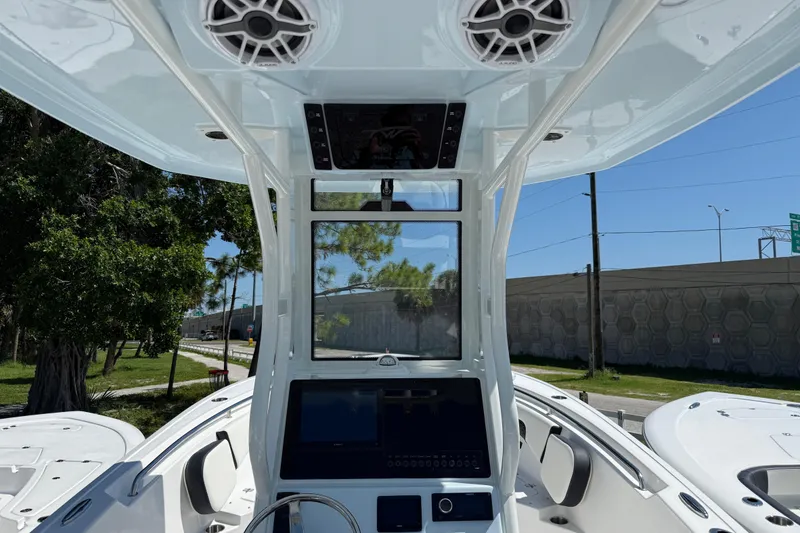 Slide: The Image of 2026 Tidewater 232 CC Adventure boat helm with modern controls and speakers. - 8