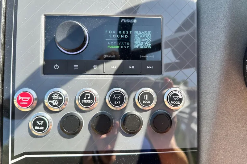 Slide: The Image of Control panel of a 2025 Tahoe 2585 boat with various function buttons and display. - 12