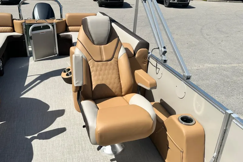 Slide: The Image of Luxurious seating on 2025 Tahoe 2585 boat, featuring tan and cream upholstery with armrests. - 16