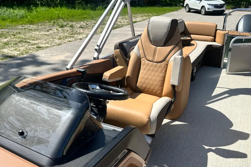 Slide: The Image of Luxurious interior of 2025 Tahoe 2585 boat with plush seating and modern steering console. - 17