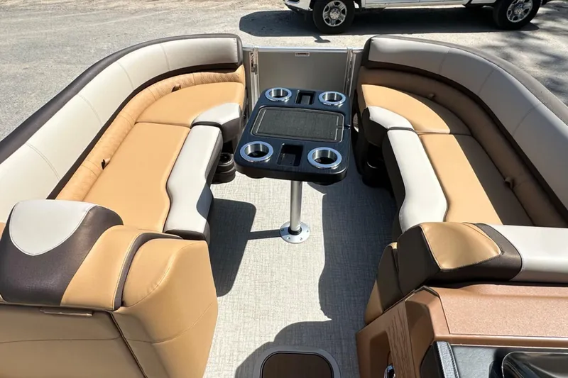 Slide: The Image of Luxurious seating area on 2025 Tahoe 2585 boat with table and cup holders. - 18