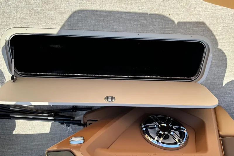 Slide: The Image of 2025 Tahoe 2585 interior storage compartment with speaker and open hatch. - 22