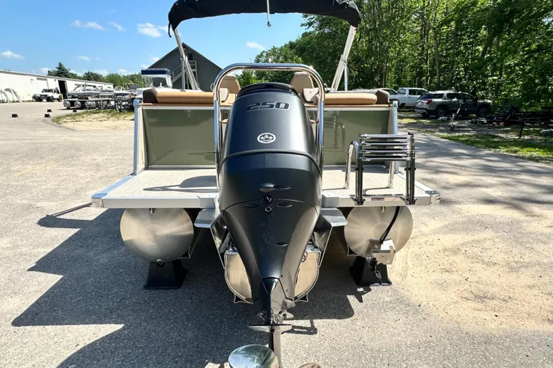 Slide: The Image of 2025 Tahoe 2585 pontoon boat with powerful 250 HP engine, parked outdoors. - 4