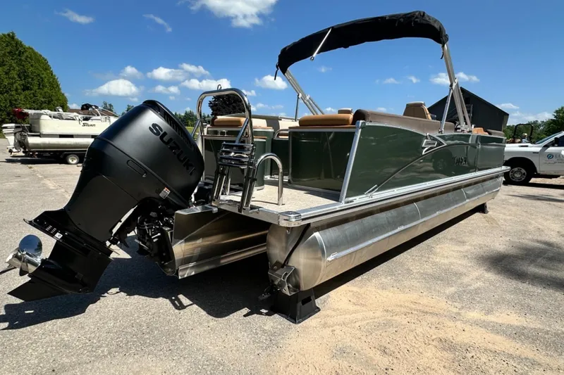 Slide: The Image of 2025 Tahoe 2585 pontoon boat with Suzuki outboard motor on a sunny day. - 5