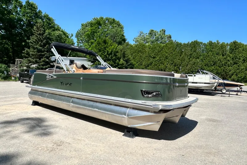 Slide: The Image of 2025 Tahoe 2585 pontoon boat parked outdoors on a sunny day. - 7