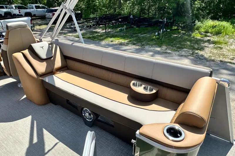 Slide: The Image of 2025 Tahoe 2585 boat interior with tan seating and cup holders. - 9