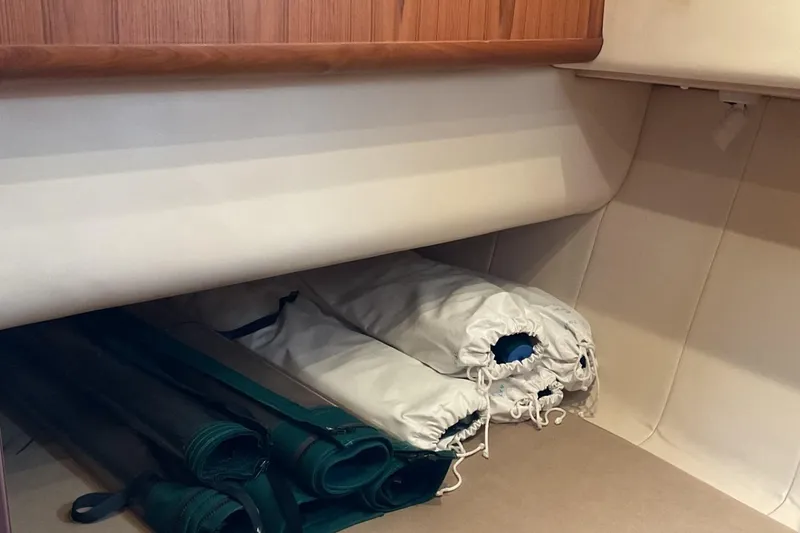 Slide: The Image of Storage area in 1999 Mainship 350 Trawler with neatly rolled sails and covers. - 15