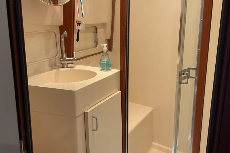 Slide: The Image of Bathroom interior of 1999 Mainship 350 Trawler with sink and shower. - 17