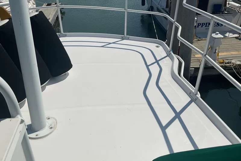 Slide: The Image of 1999 Mainship 350 Trawler deck with railings, docked at marina. - 6