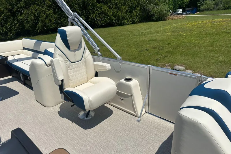 Slide: The Image of Luxurious seating on 2025 Tahoe 2585 boat, featuring plush white and blue upholstery. - 12