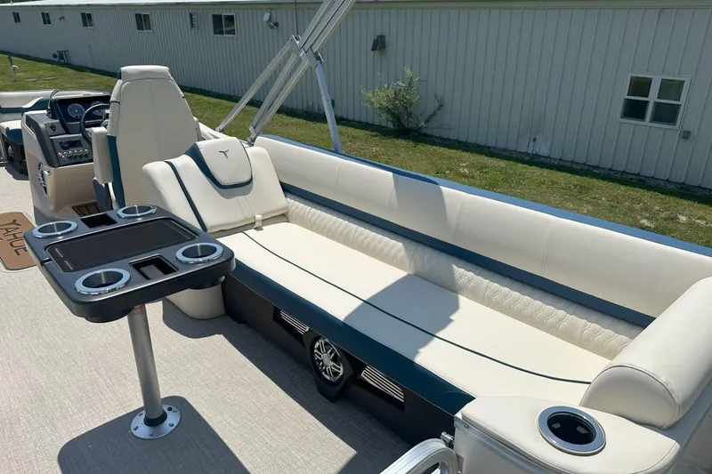 Slide: The Image of 2025 Tahoe 2585 boat interior with plush seating and cup holders. - 21