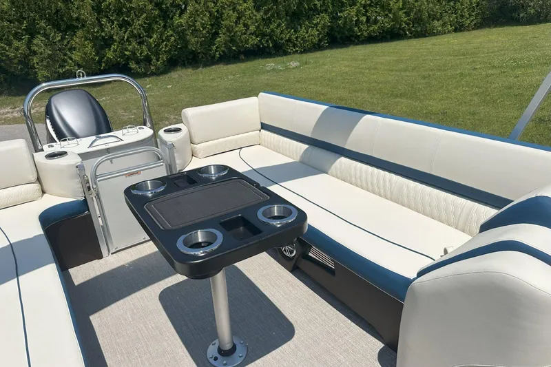 Slide: The Image of Luxurious 2025 Tahoe 2585 boat interior with plush seating and a central table. - 23