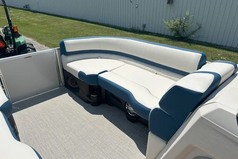 Slide: The Image of 2025 Tahoe 2585 boat interior with blue and white seating, outdoor setting. - 25
