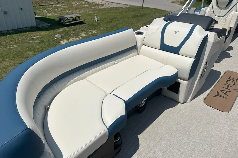 Slide: The Image of Luxurious seating on 2025 Tahoe 2585 boat, featuring blue and white upholstery. - 26
