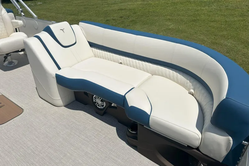 Slide: The Image of Luxurious seating on 2025 Tahoe 2585 boat, featuring blue and white upholstery. - 27