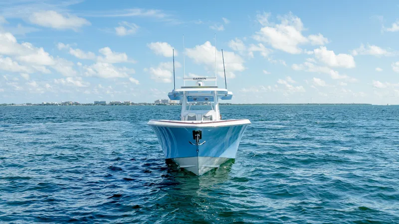 Slide: The Image of 2025 Invincible 43 Open Fisherman boat on open water under blue sky. - 8