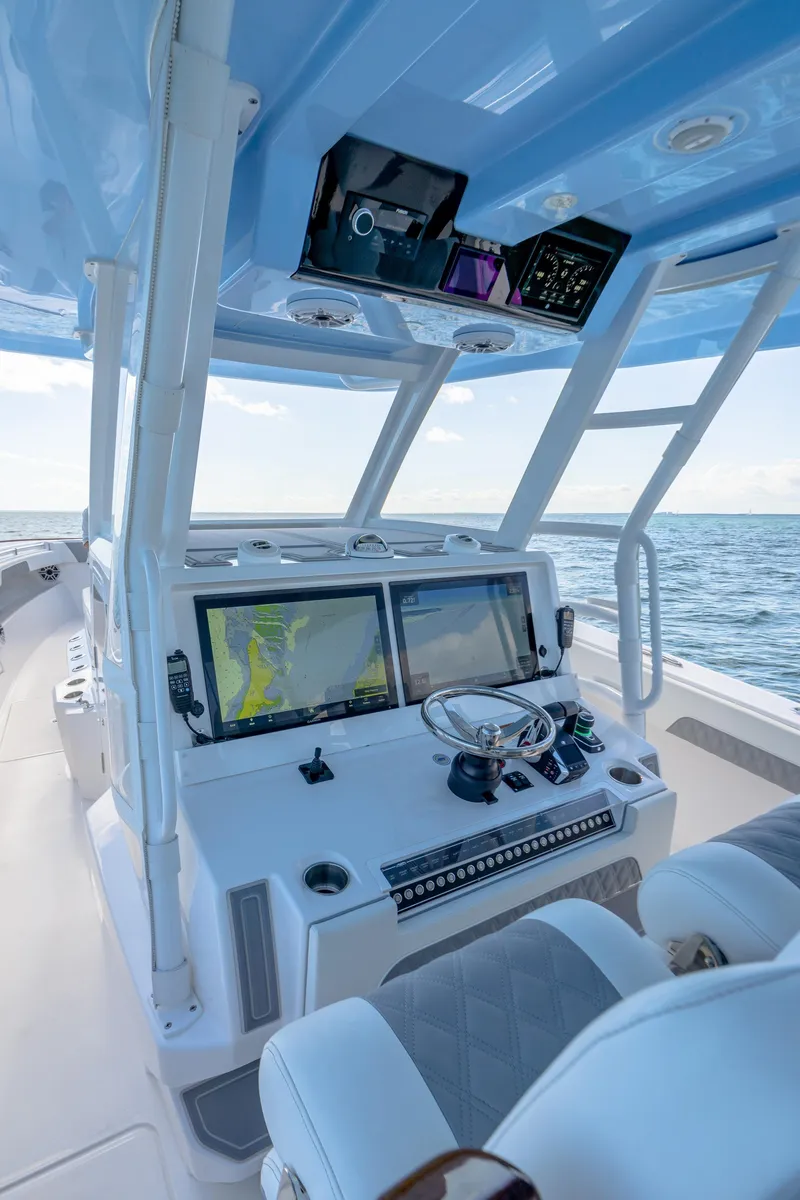 Slide: The Image of 2025 Invincible 43 Open Fisherman boat cockpit with advanced navigation systems. - 13