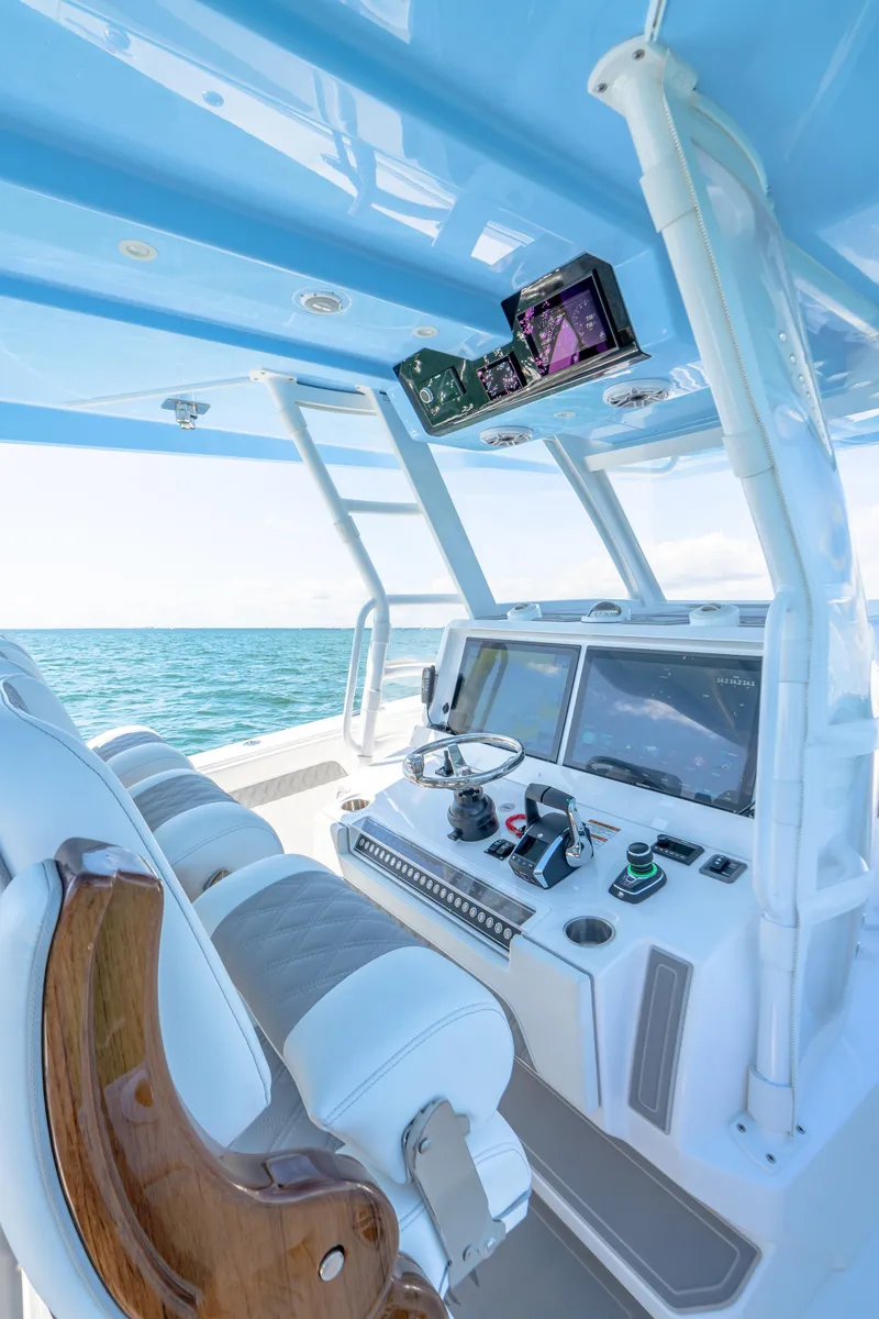 Slide: The Image of 2025 Invincible 43 Open Fisherman boat cockpit with advanced navigation systems. - 15