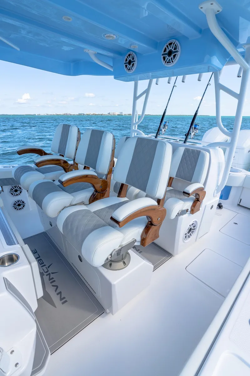 Slide: The Image of 2025 Invincible 43 Open Fisherman boat with luxurious seating and ocean backdrop. - 16