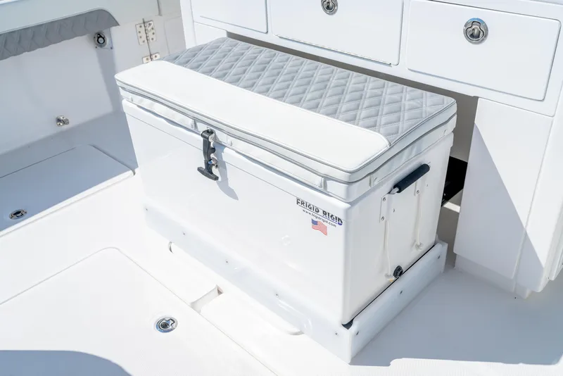 Slide: The Image of 2025 Invincible 43 Open Fisherman boat interior with cushioned storage box. - 18