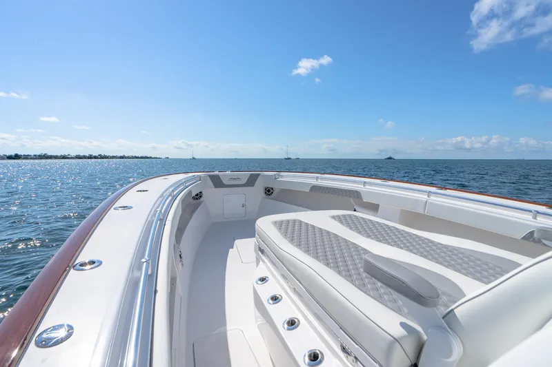 Slide: The Image of 2025 Invincible 43 Open Fisherman boat on open water, clear sky, luxury seating. - 9