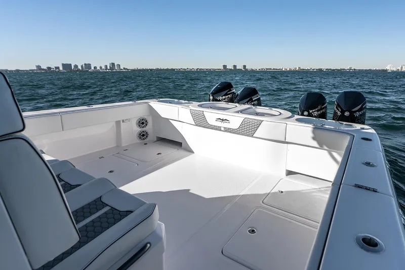 Slide: The Image of 2026 Invincible 46 Catamaran on open water, showcasing spacious deck and powerful engines. - 11