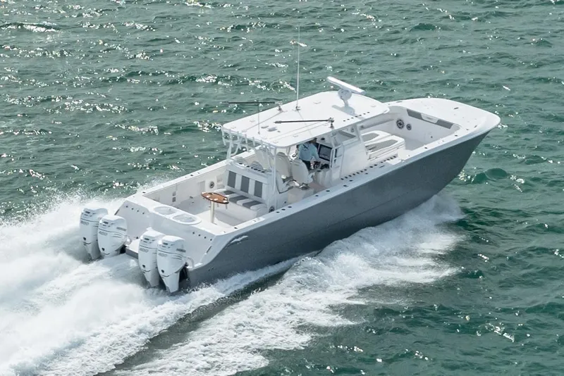 Slide: The Image of 2026 Invincible 46 Catamaran cruising on open water, showcasing sleek design and powerful engines. - 3