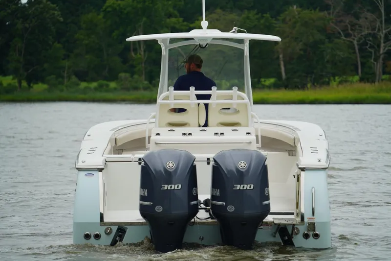 Slide: The Image of 2015 Southport 29 FE boat with dual Yamaha 300 engines on a calm river. - 10