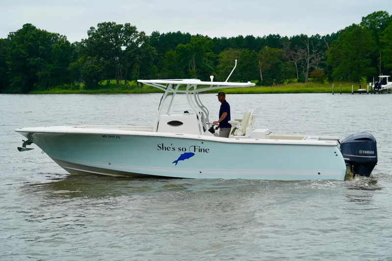 Slide: The Image of 2015 Southport 29 FE boat cruising on a calm river with lush green trees. - 13