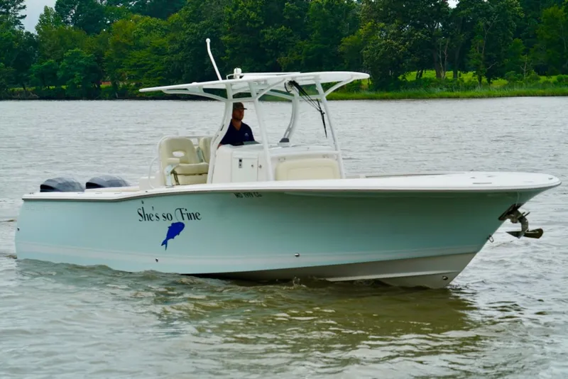 Slide: The Image of 2015 Southport 29 FE boat on water, named "She's so Fine," with lush greenery in background. - 20