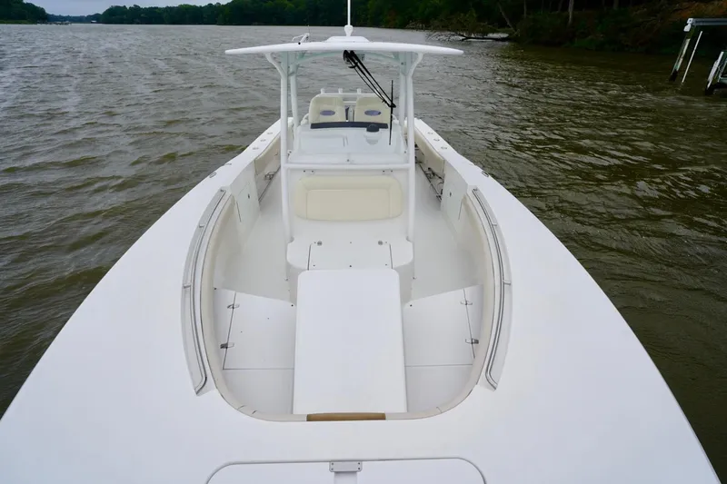 Slide: The Image of 2015 Southport 29 FE boat on calm water, showcasing spacious deck and seating. - 26