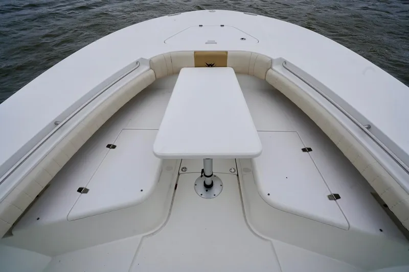 Slide: The Image of 2015 Southport 29 FE boat interior with seating and table on calm water. - 27